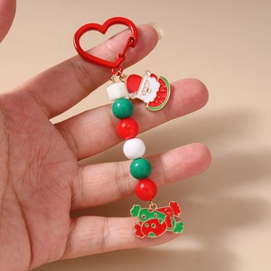 Detail of Christmas beaded keychain featuring Santa Claus and candy charms with red heart hook