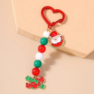 Close-up of Christmas keychain with red heart clasp, Santa charm and festive beads