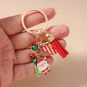 Macro detail of Christmas keychain with red tassel, Santa pendant and festive bells