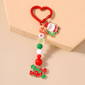Detail of Christmas keychain with Santa Claus charm, red heart clasp and festive beads