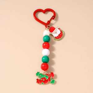Detail of Christmas keychain with red heart clasp, Santa Claus and candy cane metal charms