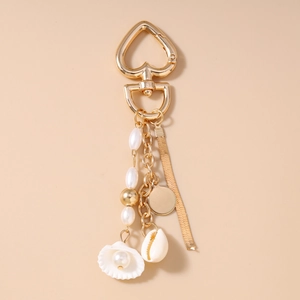 Detailed view of ocean style keychain with pearls, gold shells, and heart-shaped clasp