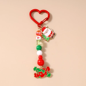 Detail of Christmas keychain with red heart clasp, Santa Claus and candy enamel charms