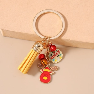 Detailed close-up of a Christmas reindeer keychain with yellow tassel and lucky charm