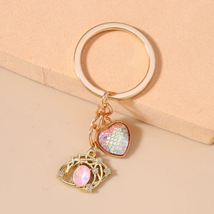 Detailed close-up of pink heart charm and starry moon gold keychain on steps