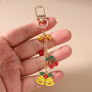 Porte-clés cerise de Noël avec cloches dorées et breloque smiley pour sac à main