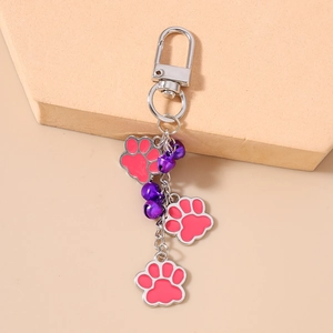 Pink cat paw pendants and purple bells charm on silver D-ring keychain setup