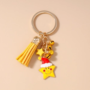 Detail of Christmas star keychain with red Santa hat, yellow tassel and golden bells