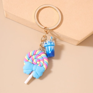 Detail of colorful spiral lollipop keychain with blue bow and miniature drink cup
