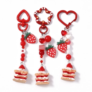 Three-piece strawberry cake keychain set with red heart beads and metal hooks