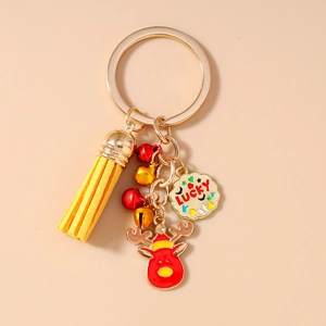Detail of Christmas reindeer keychain with leather tassel and lucky charm on golden ring