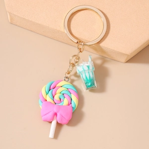 Detailed close-up of lollipop and milkshake charms with golden keychain accessories