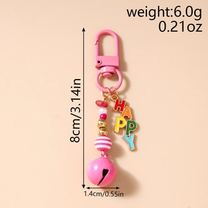 Macro shot of pink beaded keychain with bell and colorful HAPPY letter pendant charms