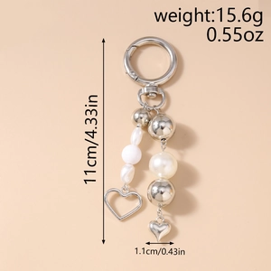 Detail showing 11cm pearl bead keychain with heart charms and silver metal clasp