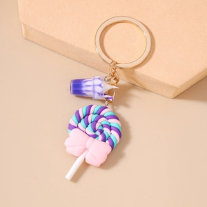 Detail of colorful swirl lollipop keychain with pink bow and gold metal ring