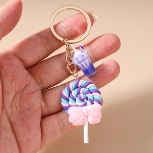 Macro shot of colorful lollipop keychain with purple mini drink cup and pink bow detail