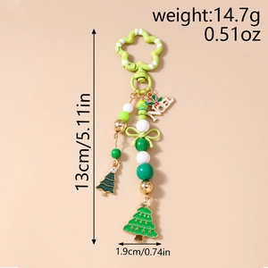Detail of Christmas keychain with NOEL letters, green enamel trees, and beaded accents