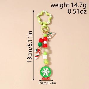 Christmas keychain detail with Noel beads, snowflake globe, candy cane and star clip