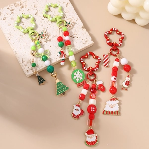 Handmade Christmas beaded keychain with festive Santa Claus and snowflake enamel charms