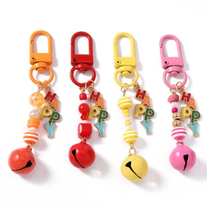 Set of four colorful beaded HAPPY keychains with large vibrant bells and metal lobster clasps