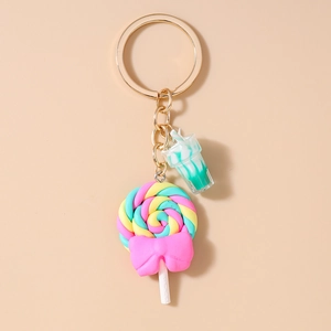 Detail of colorful rainbow swirl lollipop keychain with pink bow and mini drink cup