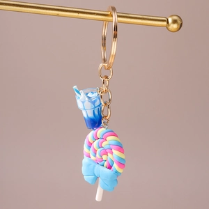 Detailed view of candy keychain with colorful spiral lollipop and blue mini drink cup