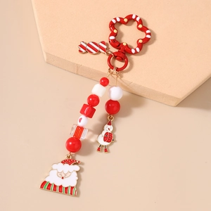 Detailed view of Christmas keychain with Santa, snowman charms and festive beaded accents