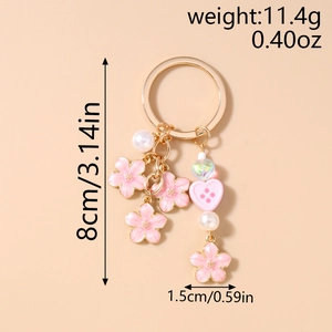 Detailed view of pink enamel cherry blossom keychain with dimensions and weight info