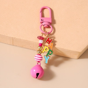 Detailed close-up of pink beaded keychain with colorful HAPPY letters and a bell