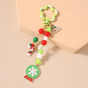 Detail view of Christmas beaded keychain with NOEL charm and enamel candy cane