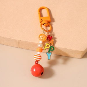 Detail of colorful beaded keychain with HAPPY rainbow letters and a red bell charm