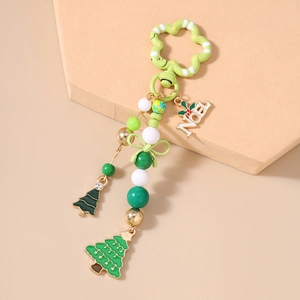 Detailed close-up of Christmas beaded keychain with NOEL charm and festive tree pendants