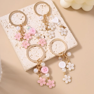 Floral keychain with pink and white enamel flowers, faux pearls and heart charms