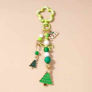 Detail of Christmas beaded keychain with flower clasp, green beads and NOEL pendants