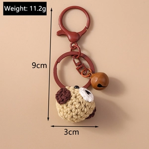 Detailed view of handmade crochet puppy keychain with 11.2g weight and 9cm length