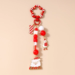 Detail of Christmas snowman keychain with beaded red and white festive holiday charms