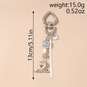 Detail view of silver heart keychain with rose charm and pearl beads showing dimensions