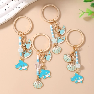 Set of 4 ocean theme keychains with gold shark, whale, shell charms and blue beads