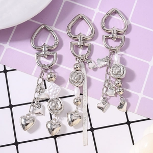 Three-piece silver alloy keychain set with tassel beads, pearls, and heart rose pendants