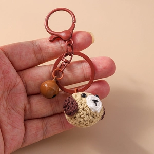 Handmade crochet puppy keychain with metallic bell and brown horseshoe clasp accessory