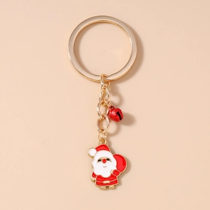 Détail d'un porte-clés de Noël doré avec clochette rouge et breloque Père Noël
