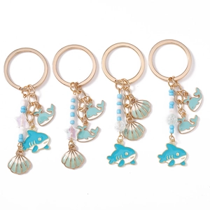 Marine themed keychain set with shark shell charms and blue tassels in gold finish