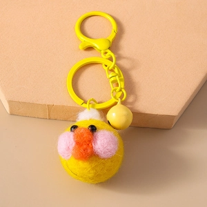 Close-up of yellow plush chick keychain with metal spring clasp and matching small bell