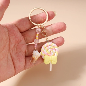 Detailed view of handmade lollipop and cream cup charms on a colorful beaded keychain