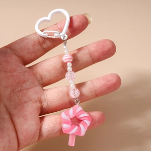 Detailed close-up of a sweet pink star beaded keychain with heart hook and tassels