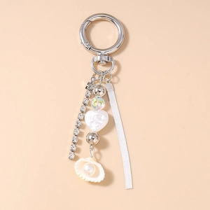 Detail of silver snake chain keychain with shell pearl and sparkling crystal fringe