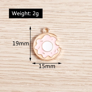 Macro shot of 19mm pink donut charm with bite mark detail and golden alloy edges