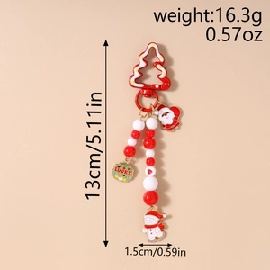 Detail of Christmas beaded keychain with Santa, snowman charms and lucky gold tag