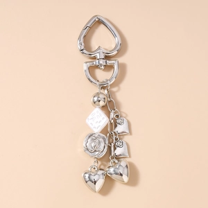 Detail of silver tassel keychain with beads, roses and heart-shaped metal charms