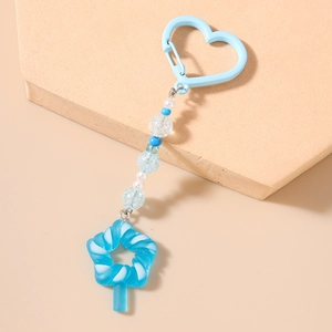 Close-up of blue star candy charm keychain with heart clasp and beaded tassel decoration